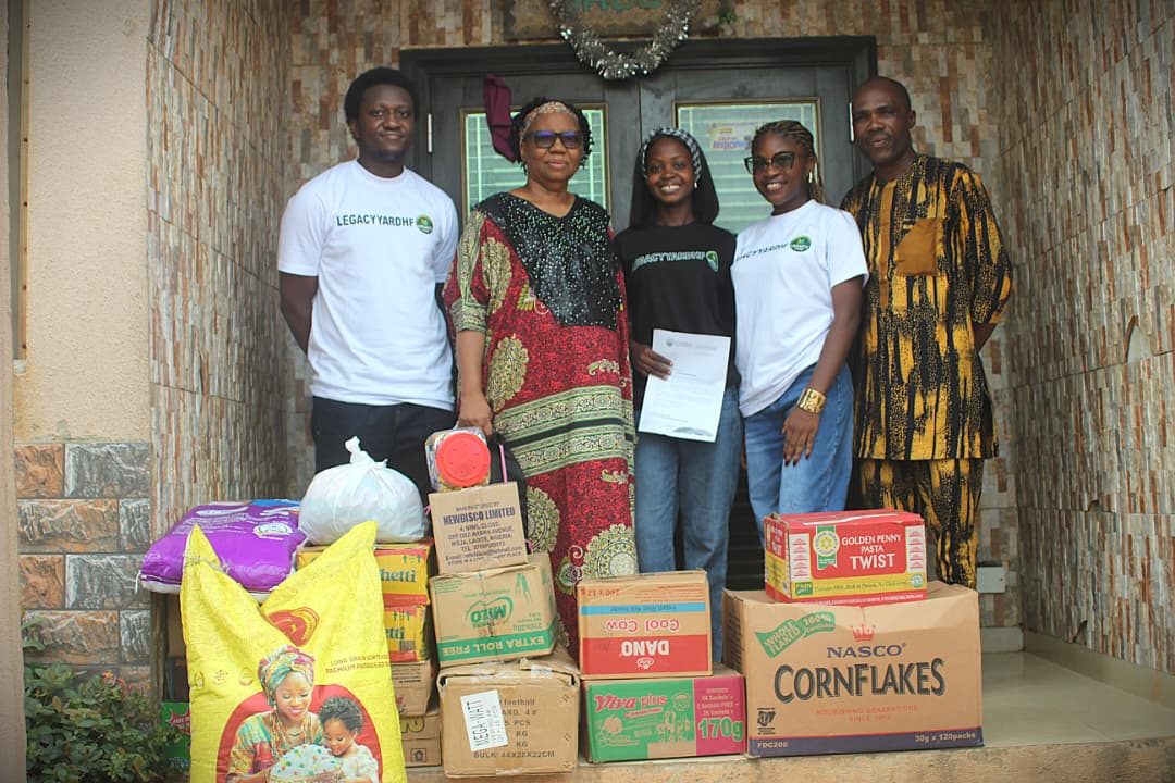LYHF team members with the centre's director and boxes of donated food and supplies